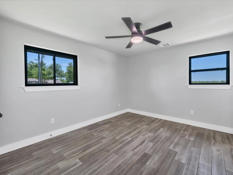 2719 Post Oak Road Webberville, TX 78653 - Photo 15 of 23 a view of an empty room with wooden floor and a ceiling fan