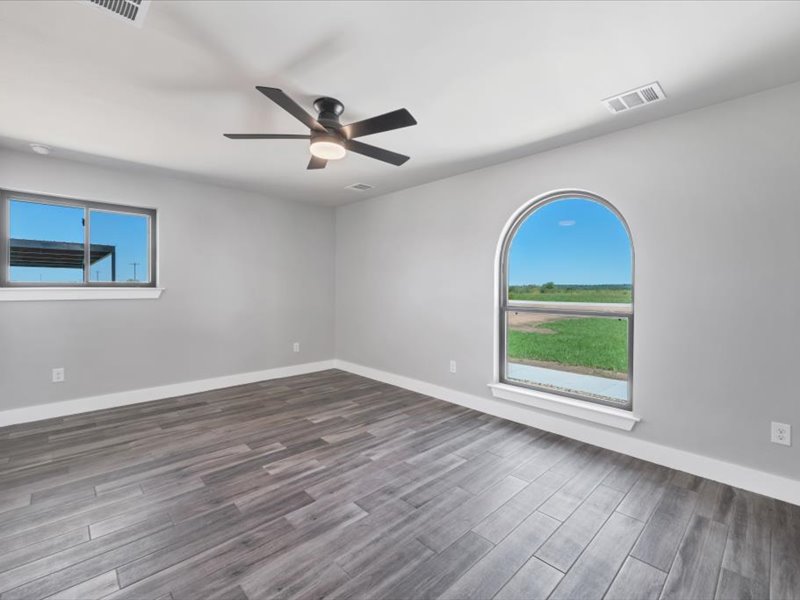 2719 Post Oak Road Webberville, TX 78653 - Photo 16 of 23 a view of an empty room with wooden floor and a window