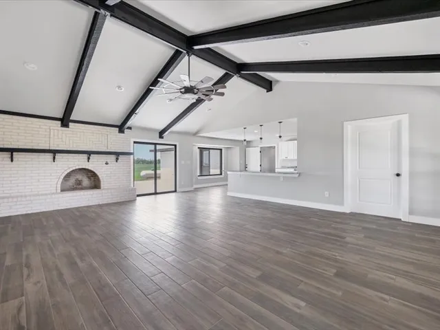 a view of a house with a yard and a large tree