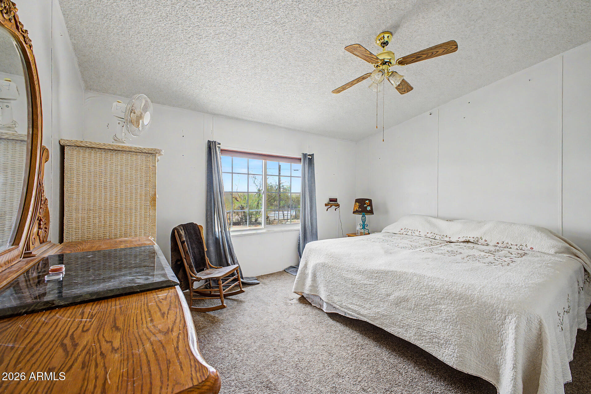 8595 North Palo Verde Road Florence, AZ 85132 - Photo 12 of 41 a bedroom with a bed a table and chair
