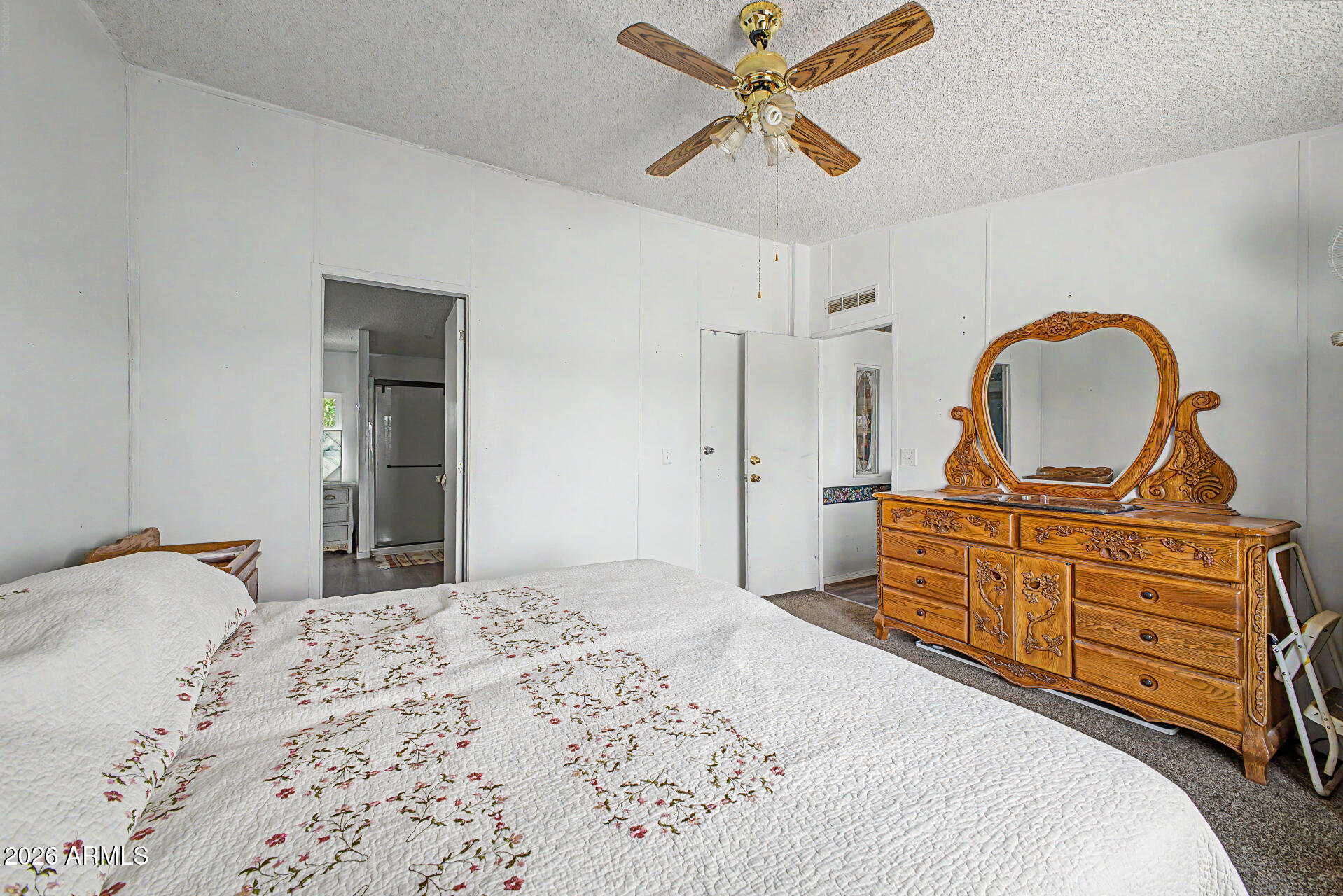 8595 North Palo Verde Road Florence, AZ 85132 - Photo 13 of 41 a bedroom with a bed and a dresser