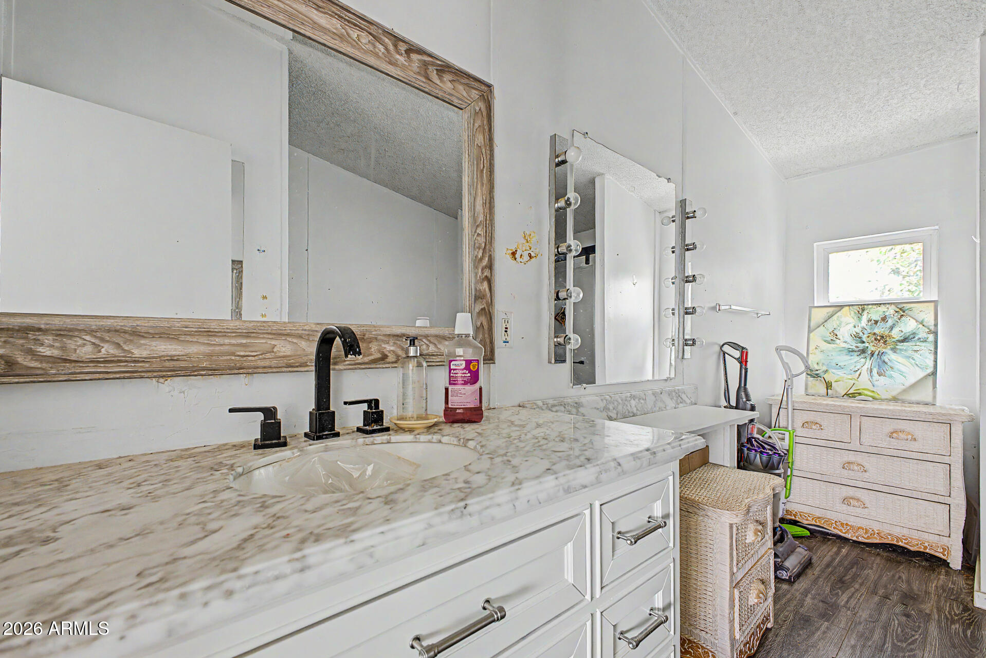 8595 North Palo Verde Road Florence, AZ 85132 - Photo 14 of 41 a bathroom with a granite countertop sink a mirror and a shower