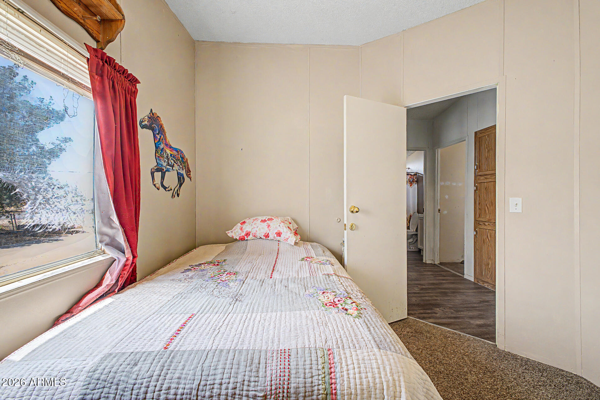 8595 North Palo Verde Road Florence, AZ 85132 - Photo 17 of 41 a view of a bedroom with wooden floor and windows