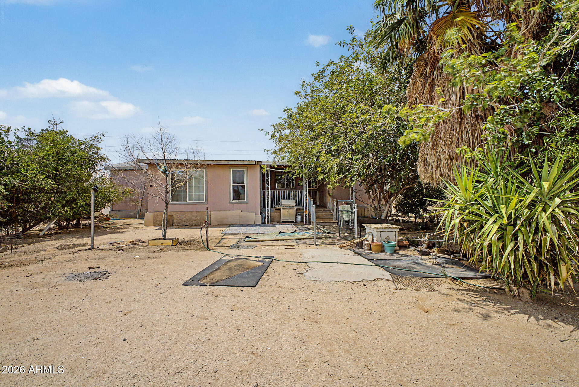 8595 North Palo Verde Road Florence, AZ 85132 - Photo 26 of 41 a backyard of a house with table and chairs under an umbrella