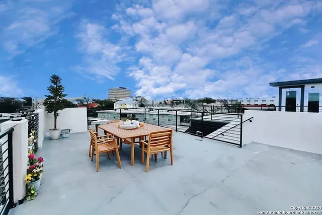 a terrace with outdoor seating and city view