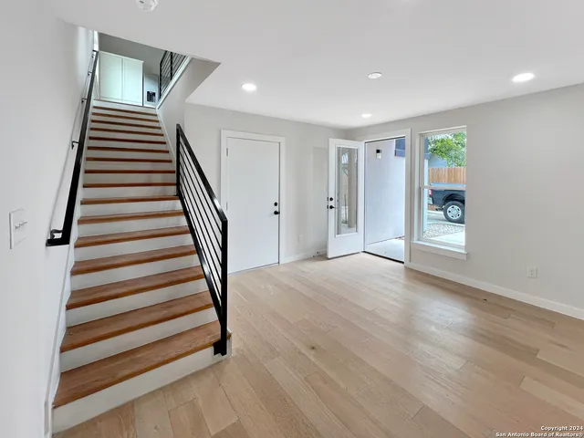 a view of entryway with stairs and wooden floor