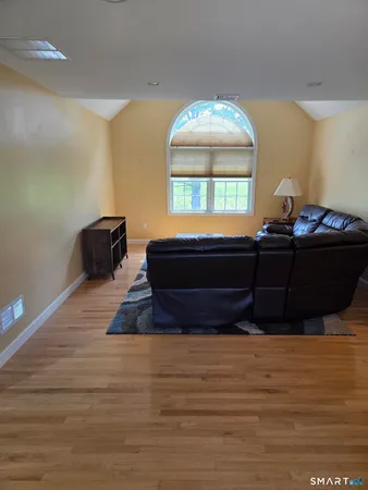 a living room with a bed furniture and a window