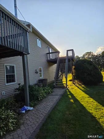 a view of a house with backyard and porch
