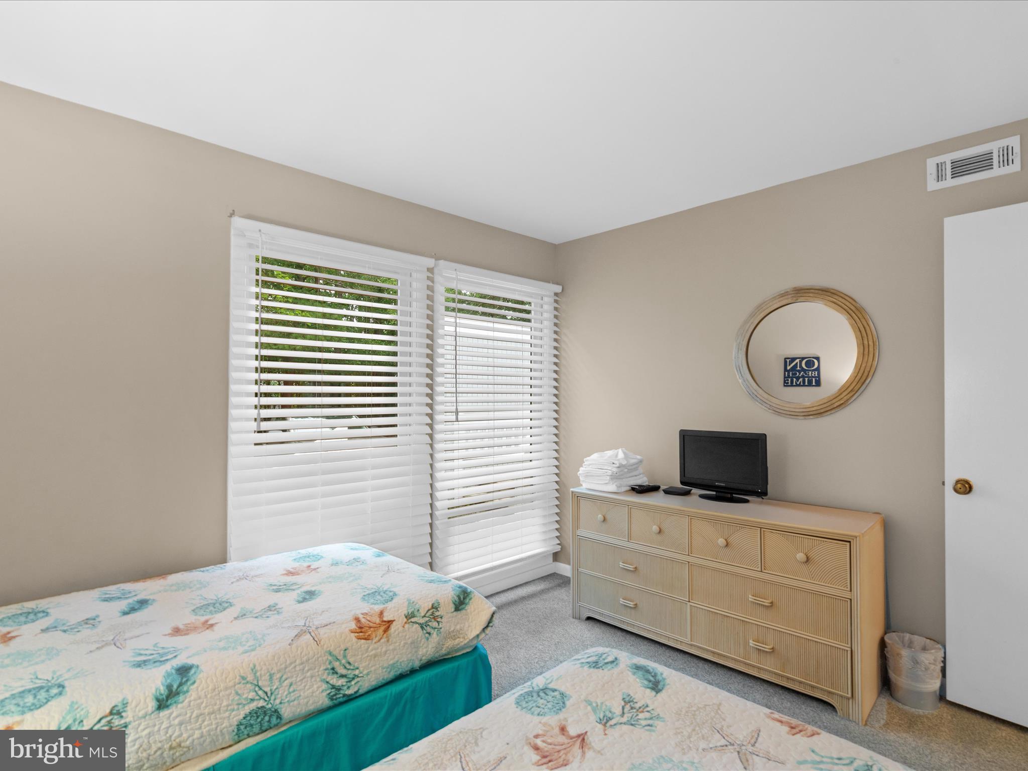 39346 Racquet Lane, Unit 8504 Bethany Beach, DE 19930 - Photo 22 of 40 a bedroom with a bed and a flat screen tv