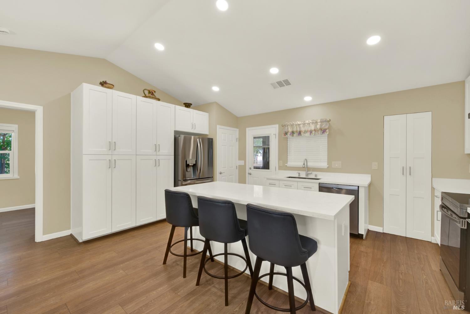 4851 Udell Road Vacaville, CA 95688 - Photo 3 of 65 a kitchen with stainless steel appliances a dining table chairs and wooden floor