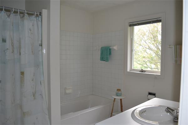 155 Sakonnet Point Road Little Compton, RI 02837 - Photo 11 of 15 a bath room with a toilet and a bath tub