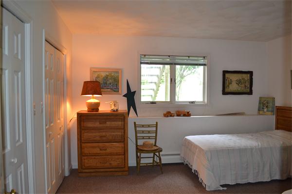 155 Sakonnet Point Road Little Compton, RI 02837 - Photo 13 of 15 a bedroom with a bed and a dresser