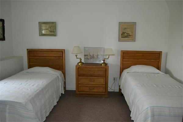 155 Sakonnet Point Road Little Compton, RI 02837 - Photo 14 of 15 a bedroom with a bed and furniture