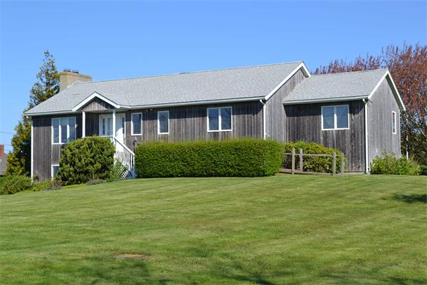 155 Sakonnet Point Road Little Compton, RI 02837 - Photo 9 of 15 a front view of house with yard and green space