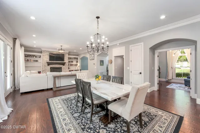 a large kitchen with stainless steel appliances granite countertop a stove oven and a white cabinets