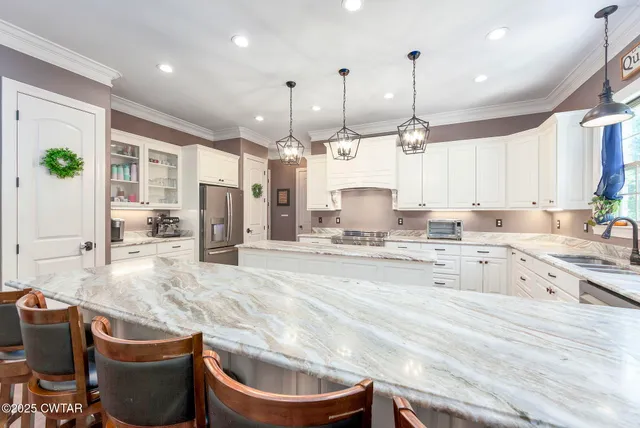 a view of a kitchen with a stove wooden floor and a window