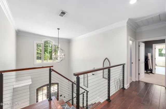 a bedroom with a large bed and a chandelier