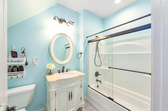 a living room with furniture a flat screen tv and a rug