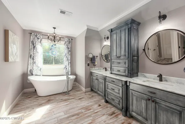a en suite bathroom with a granite countertop sink and a mirror