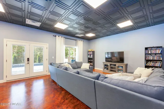 a view of a room with wooden floor and iron stairs