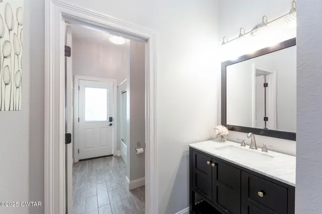 an aerial view of a house with a garden and lake view