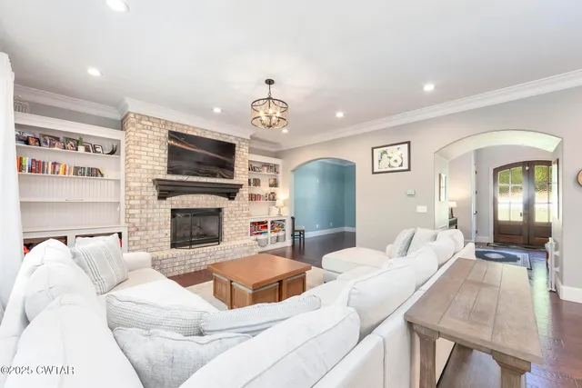 a living room with furniture and a chandelier