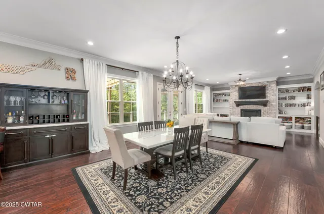 a large kitchen with kitchen island a large counter space a sink stainless steel appliances and cabinets