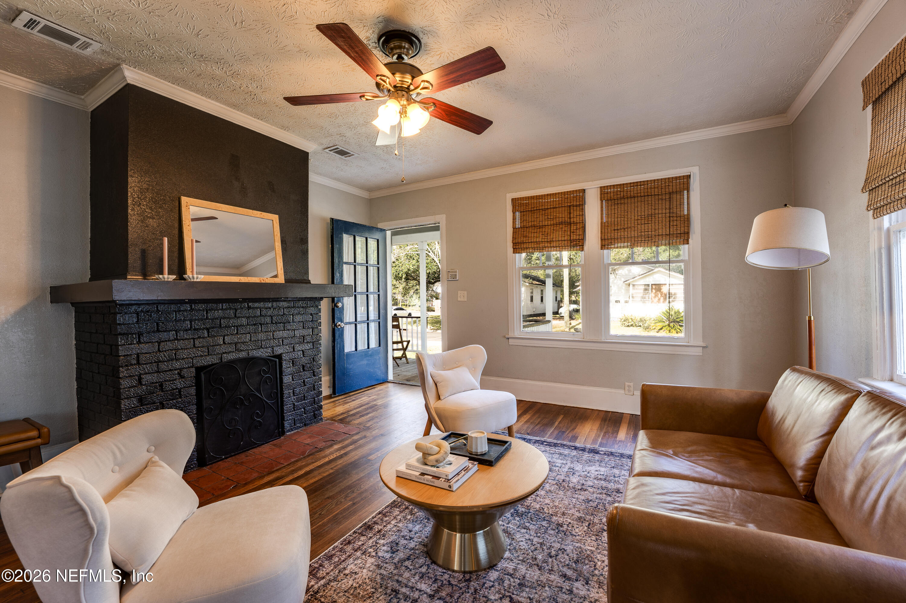 4560 French Street Jacksonville, FL 32205 - Photo 9 of 38 a living room with furniture a fireplace and a large window