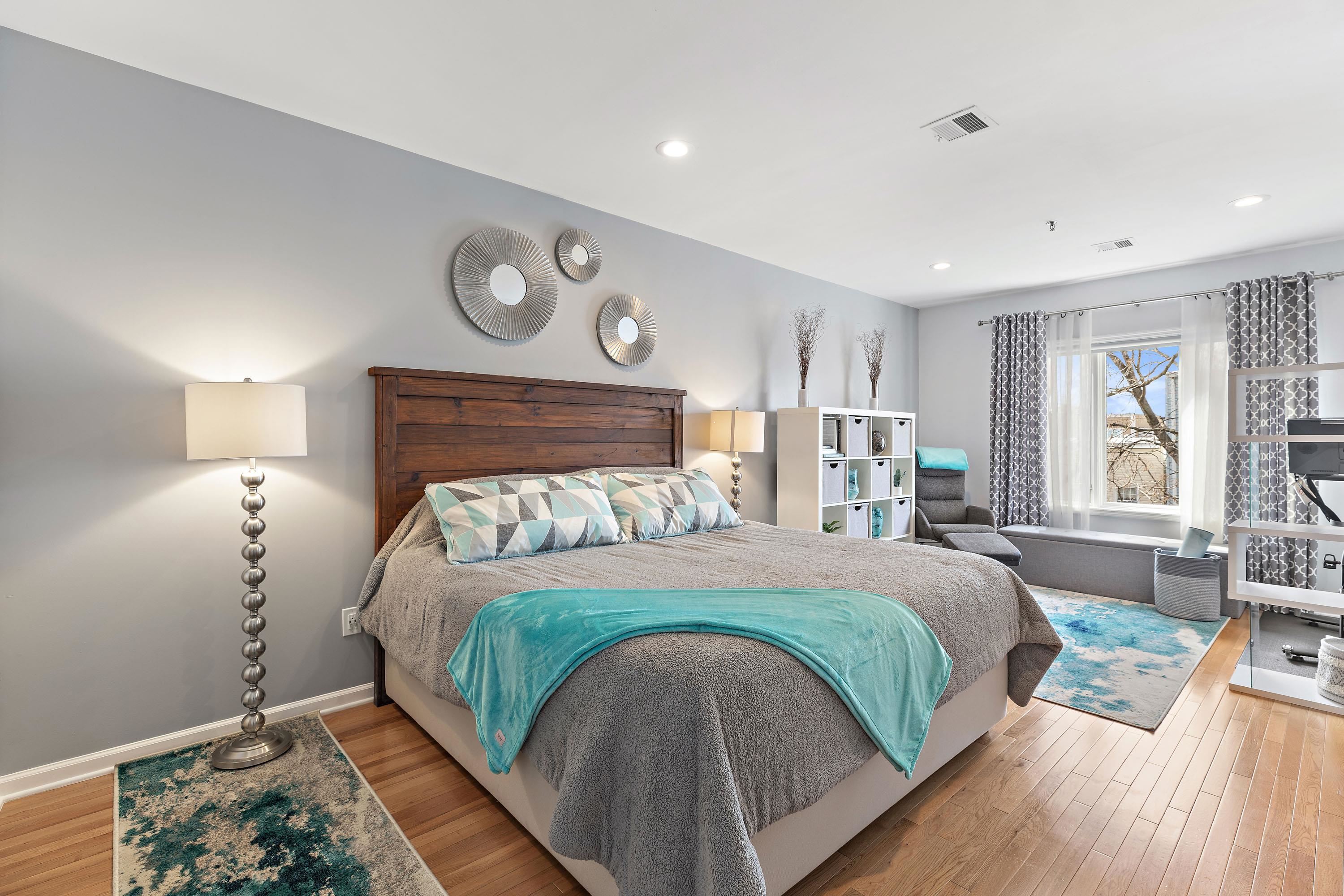 203-207 Hackensack Plank Road, Unit 4B Weehawken, NJ 07086 - Photo 12 of 27 a bed sitting in a bedroom next to a window