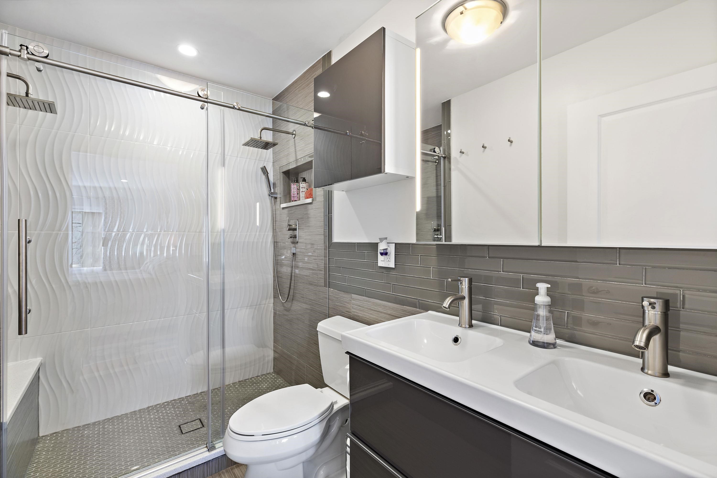 203-207 Hackensack Plank Road, Unit 4B Weehawken, NJ 07086 - Photo 17 of 27 a bathroom with a sink toilet a mirror and shower