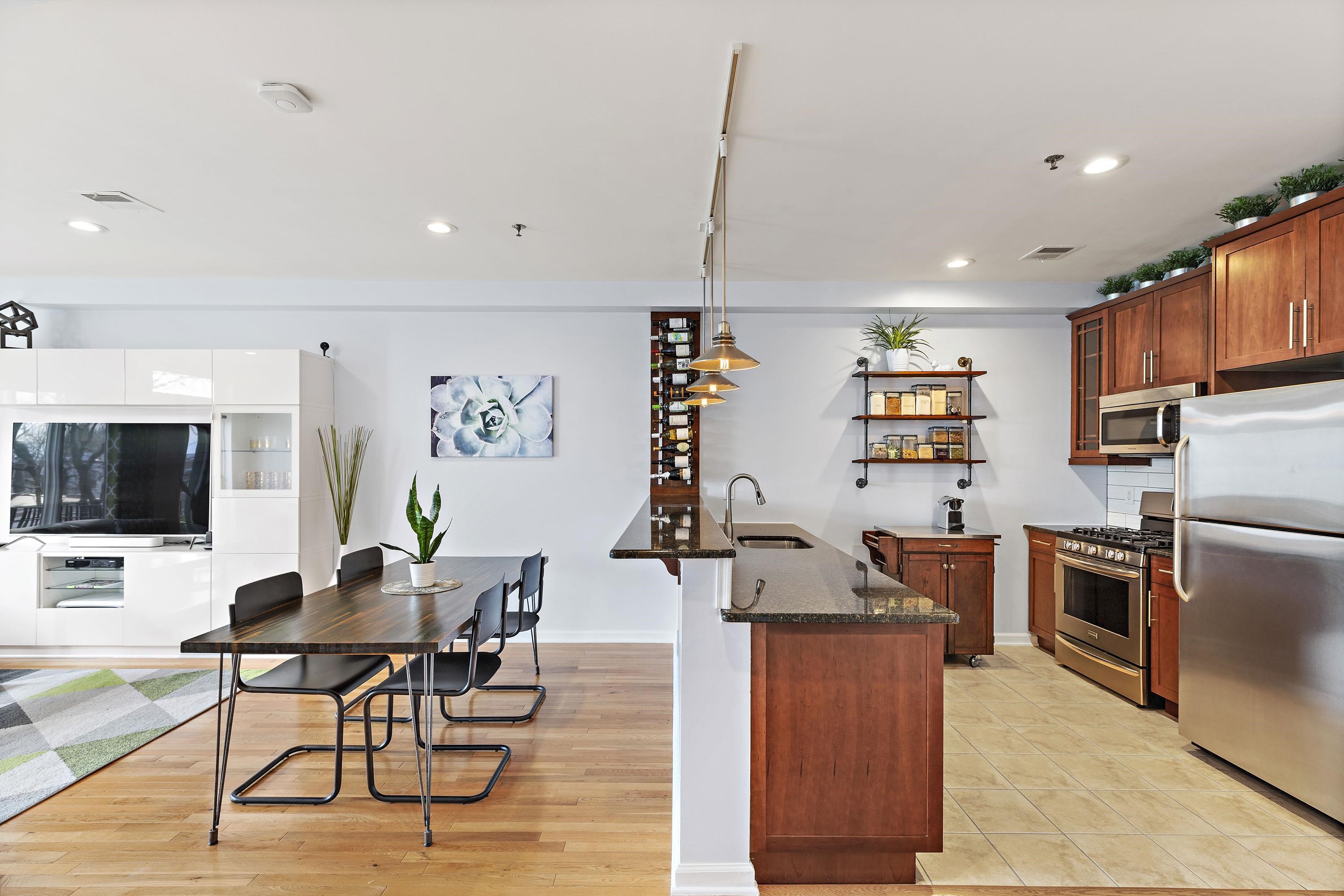 203-207 Hackensack Plank Road, Unit 4B Weehawken, NJ 07086 - Photo 18 of 27 a living room with furniture a flat screen tv and kitchen view