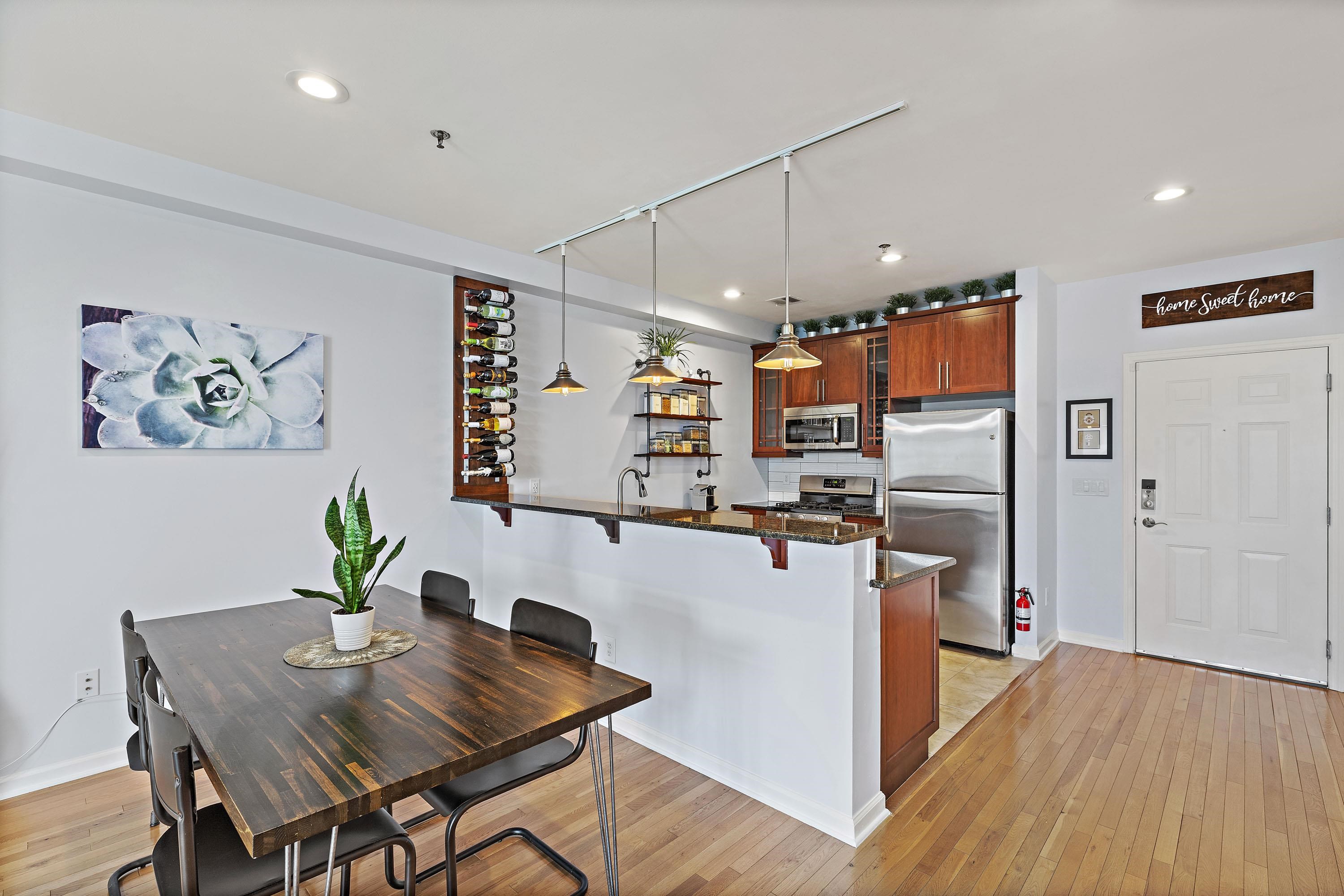 203-207 Hackensack Plank Road, Unit 4B Weehawken, NJ 07086 - Photo 3 of 27 a view of a dining room with furniture wooden floor and a kitchen