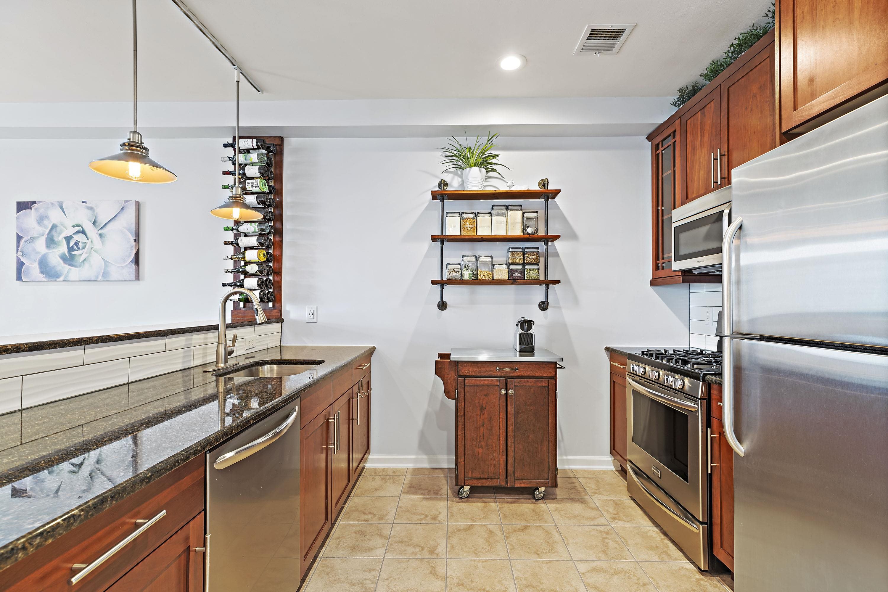 203-207 Hackensack Plank Road, Unit 4B Weehawken, NJ 07086 - Photo 4 of 27 a kitchen with stainless steel appliances a stove a sink and a refrigerator