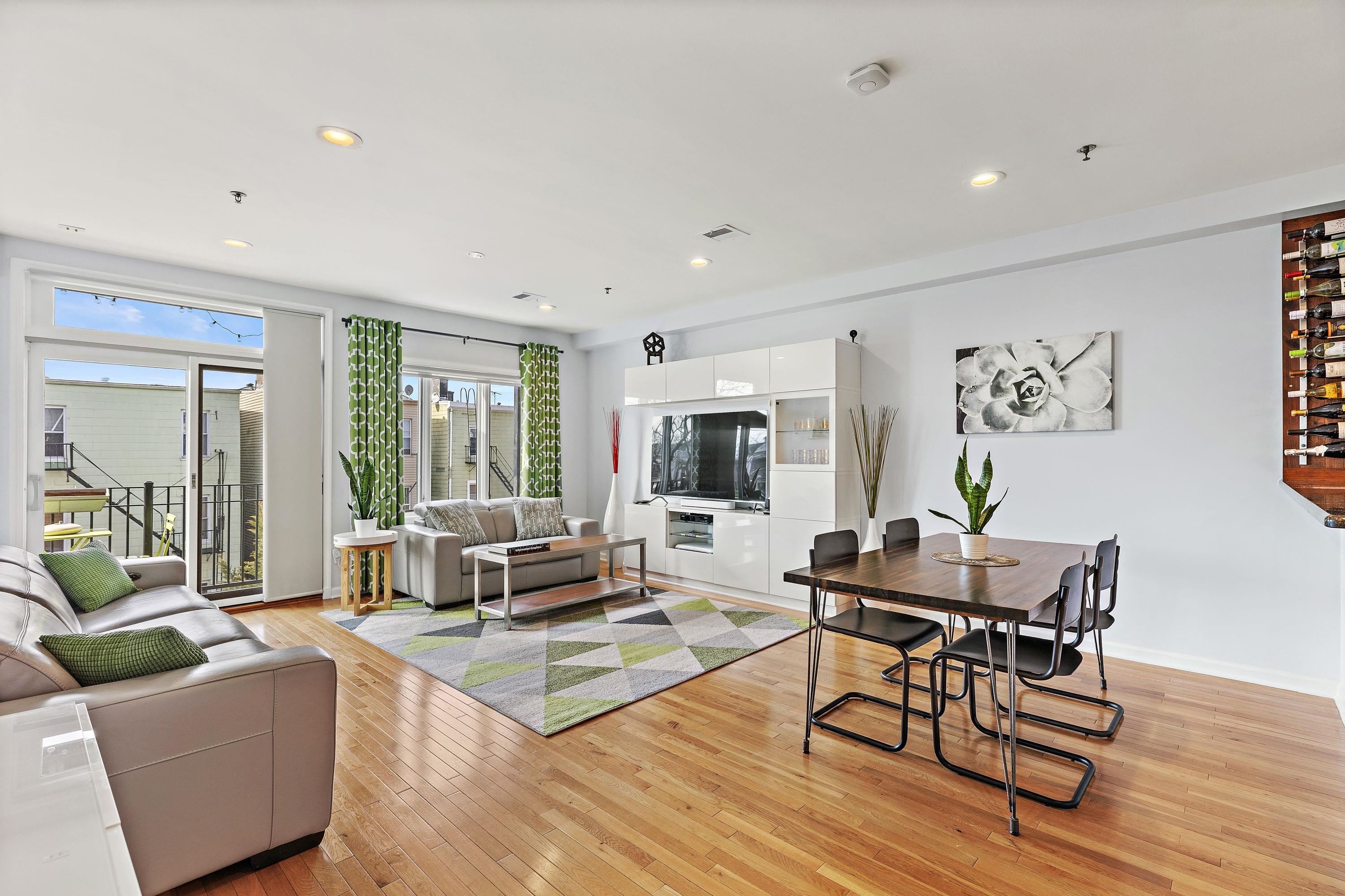 203-207 Hackensack Plank Road, Unit 4B Weehawken, NJ 07086 - Photo 5 of 27 a living room with furniture and a large window