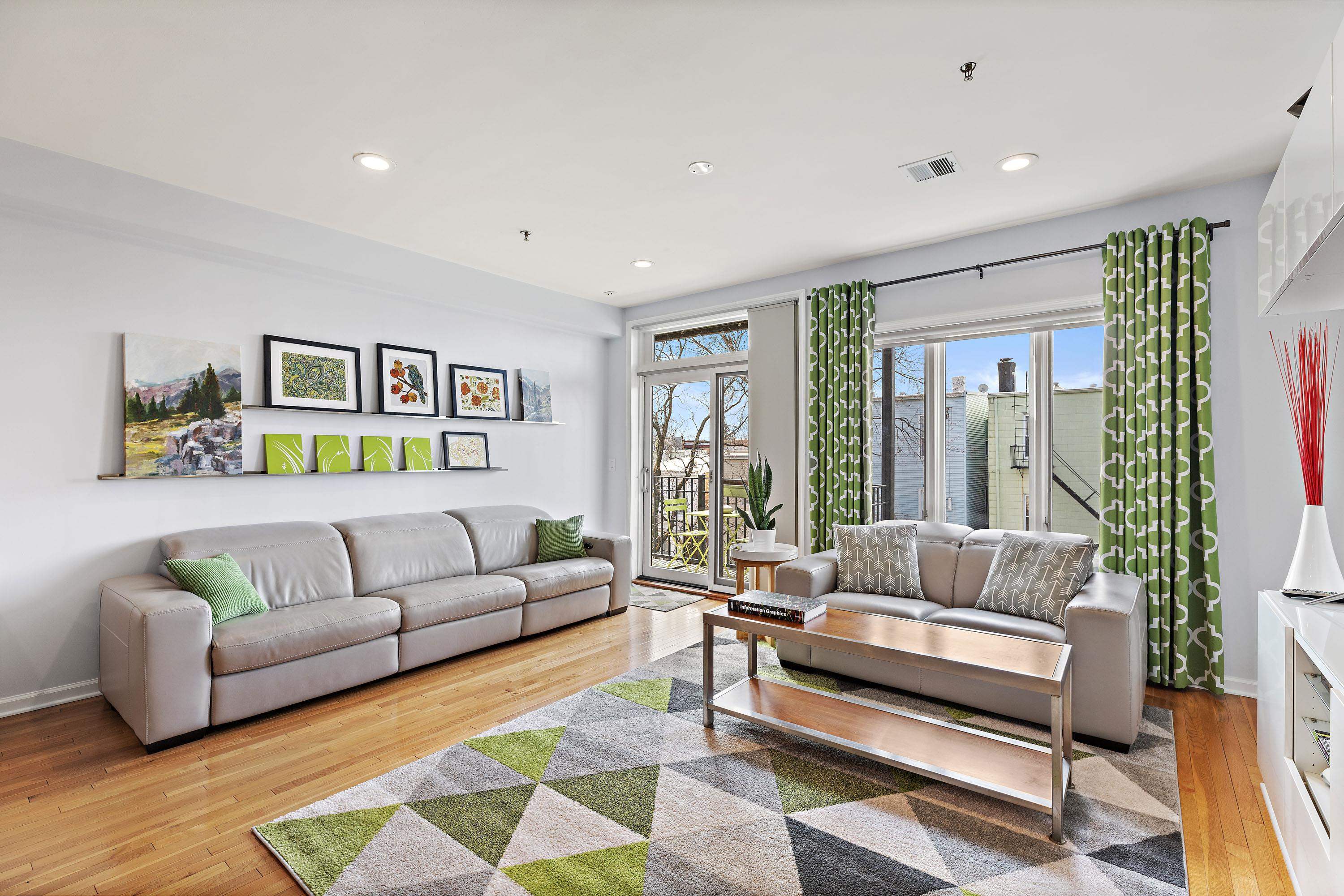 203-207 Hackensack Plank Road, Unit 4B Weehawken, NJ 07086 - Photo 8 of 27 a living room with furniture and a large window