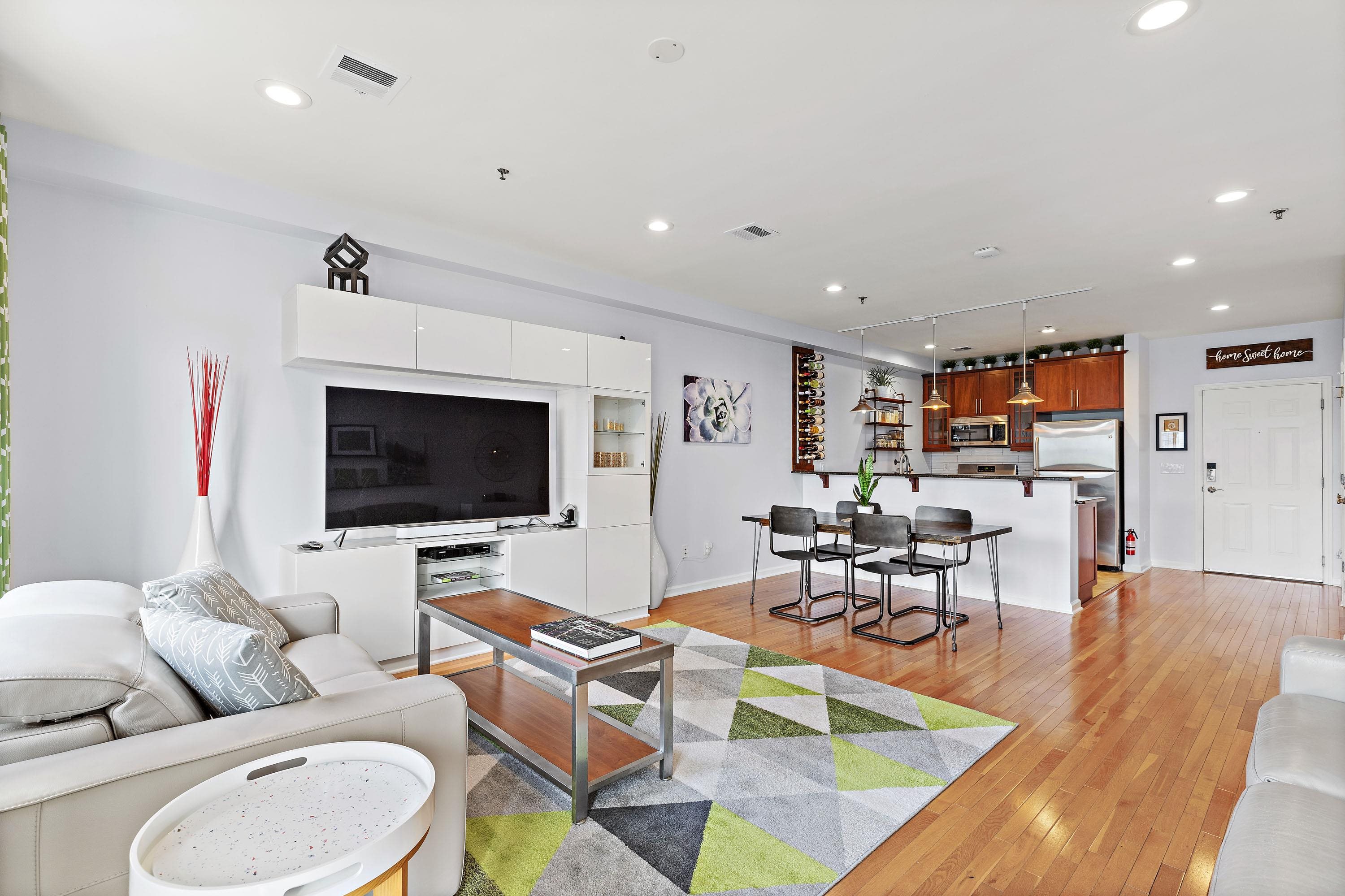 203-207 Hackensack Plank Road, Unit 4B Weehawken, NJ 07086 - Photo 9 of 27 a living room with furniture and a flat screen tv