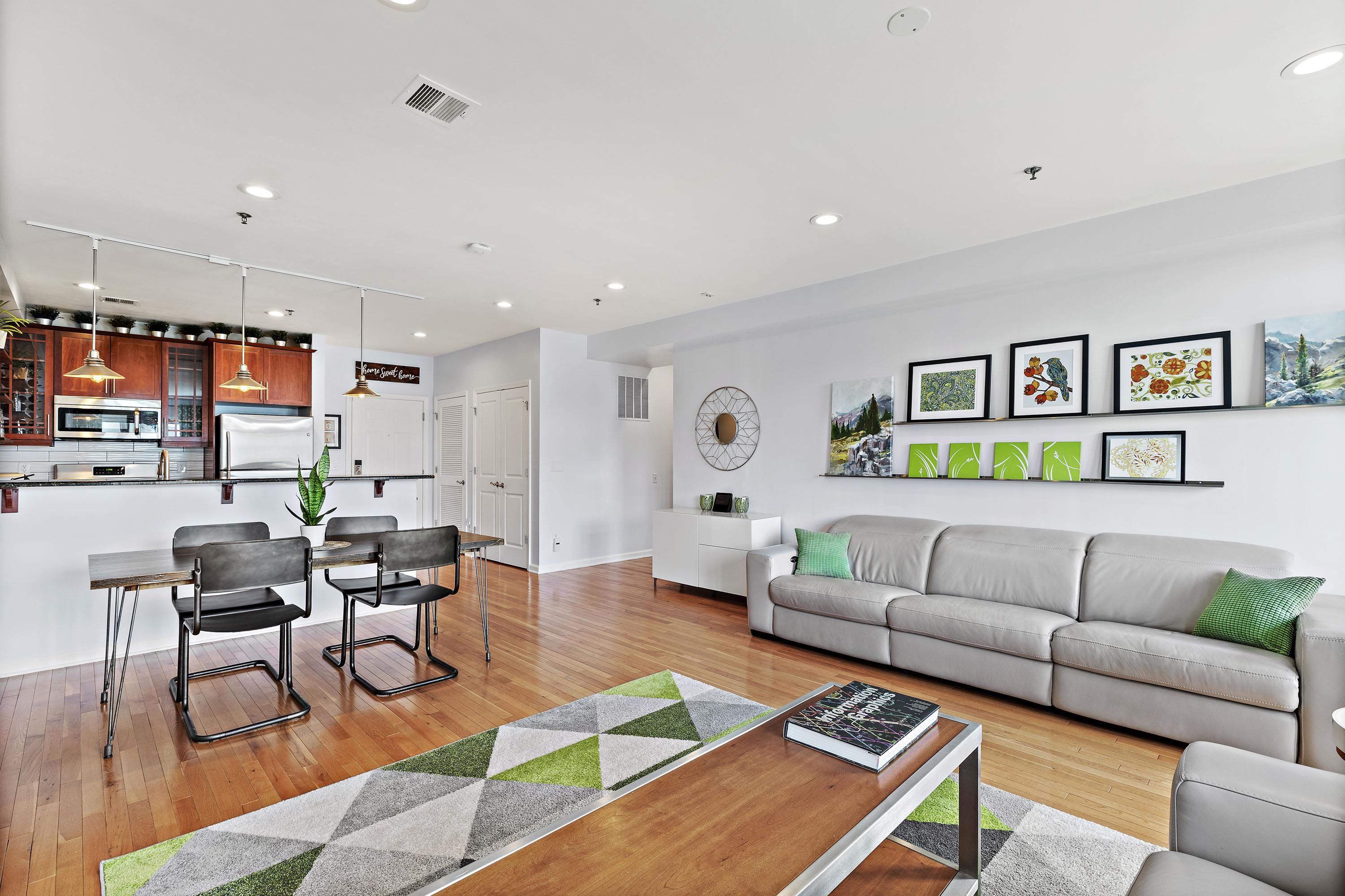 203-207 Hackensack Plank Road, Unit 4B Weehawken, NJ 07086 - Photo 10 of 27 a living room with furniture kitchen view and a table