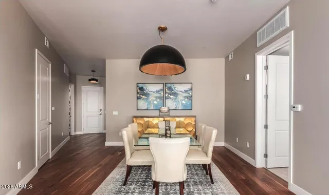 a view of a dining room with furniture and wooden floor