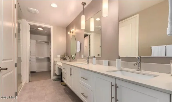 a bathroom with a tub shower and sink