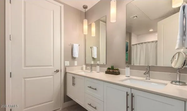 a bathroom with a shower curtain and a sink