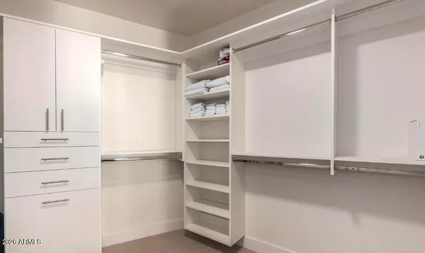 a bedroom with a bed and a tv