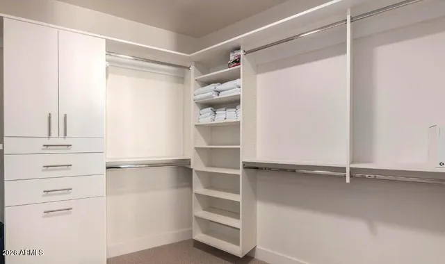 a bedroom with a bed and a tv