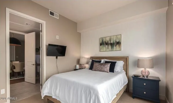 a bedroom with a bed and a flat screen tv