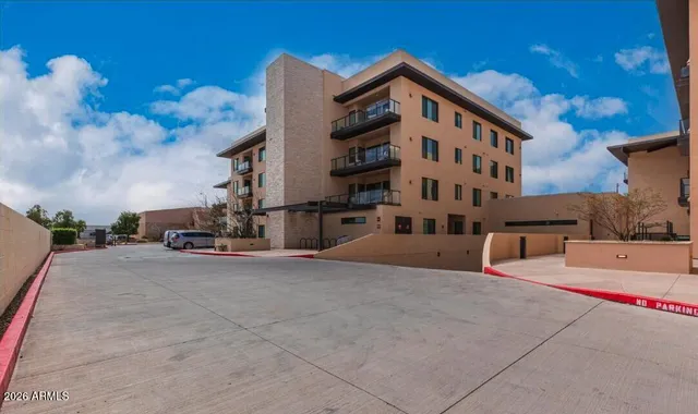 a living room with furniture potted plant and a large window