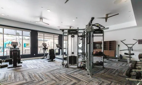 a view of a patio with a table and chairs and barbeque grill