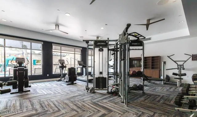 a view of a patio with a table and chairs and barbeque grill