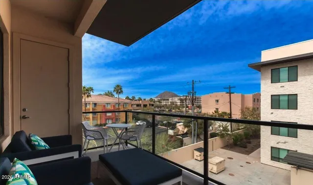 a view of a building with many windows and plants