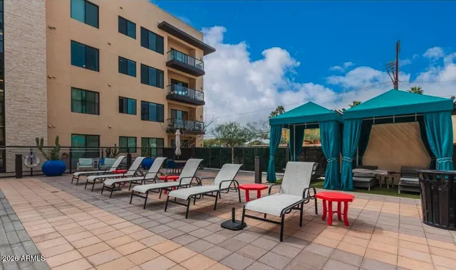 a kitchen with a table chairs a stove and a window