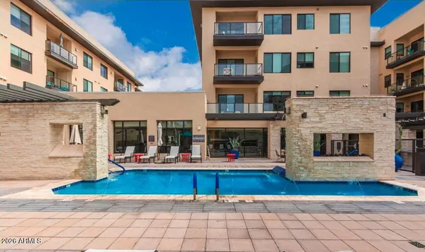 a living room with furniture and a book shelf