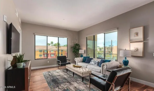 a kitchen with a table chairs refrigerator and couch